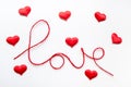 Valentine\'s day concept. Red heart and word love made from woolen rope on white background