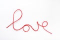 Valentine\'s day concept. Red heart and word love made from woolen rope on white background with copy space