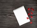 Valentine`s day concept with red hearts. Notepad with a blank sheet on a wooden background with hearts. Love letter