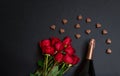 Valentine`s day concept. Red roses,  bottle of champagne and  heart shape chocolate candies Royalty Free Stock Photo