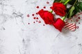 Valentine`s Day Concept. Red roses and heart decor on Ultimate Gray background.