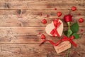 Valentine`s day concept with rose flower, gift box and heart shape chocolate on wooden background. Royalty Free Stock Photo