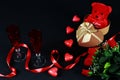 Valentine`s day concept. Teddy bear in heart shaped gift box with candle and red champagne glass on black background. Royalty Free Stock Photo