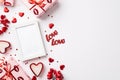 Valentine`s Day concept. Top view photo of photo frame gift boxes in wrapping paper with kiss lips pattern red hearts confetti Royalty Free Stock Photo