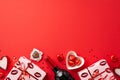 Valentine`s Day concept. Top view photo of gift boxes wine bottle candles plate with heart shaped candies and confetti on isolate Royalty Free Stock Photo