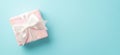 Valentine`s Day concept. Top view photo of pastel pink giftbox with white ribbon bow on isolated light blue background with Royalty Free Stock Photo