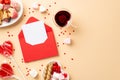 Valentine`s Day concept. Top view photo of red envelope with paper sheet plates with sweets cookies candies lollipops and heart Royalty Free Stock Photo
