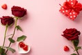 Valentine`s Day concept. Top view photo of red roses heart shaped saucer with chocolate candies and present box on isolated paste Royalty Free Stock Photo