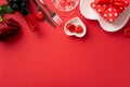 Valentine`s Day concept. Top view photo of wine bottle glass giftbox rose heart shaped plates cutlery and chocolate candies on Royalty Free Stock Photo