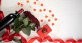 Valentine's day concept. Top view table with setting for romantic dinner, bottle of wine, red gift box and roses Royalty Free Stock Photo