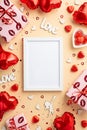 Valentine`s Day concept. Top view vertical photo of photo frame gift boxes heart shaped balloons candies inscription love cupid Royalty Free Stock Photo