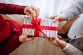 Valentine`s day concept. Top view of a woman opening a giftbox with red ribbon in hands. Loving couple give each other presents o Royalty Free Stock Photo