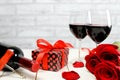 A glasses of wine, roses and gift Royalty Free Stock Photo