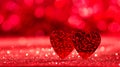 Valentine`s day concept. Two red hearts on bright sparkling background