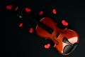 Valentine`s Day concept with violin and red hearts