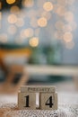 Valentine`s day concept. Wooden cube calendar with 14th february date on the bed. Bokeh golden background. copy space Royalty Free Stock Photo