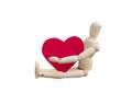 Valentine`s day concept. Wooden dummy hug a heart shape that made from acrylic felt fabric Royalty Free Stock Photo