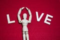 Valentine`s day concept. wooden puppet on ted color acrylic felt. Royalty Free Stock Photo