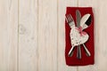 Valentine`s day concept. On the wooden table cutlery on linen na
