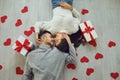 Valentine`s day. Couple gives heart to the Valentine`s Day in the room. Top view