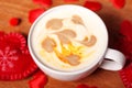 Valentine`s day. A Cup of cappuccino with a heart-shaped latte art on a wooden table. The concept of Declaration of love Royalty Free Stock Photo