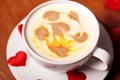 Valentine`s day. A Cup of cappuccino with a heart-shaped latte art on a wooden table. The concept of Declaration of love Royalty Free Stock Photo