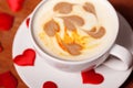 Valentine`s day. A Cup of cappuccino with a heart-shaped latte art on a wooden table. The concept of Declaration of love Royalty Free Stock Photo