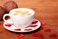 Valentine`s day. A Cup of cappuccino with a heart-shaped latte art on a wooden table. The concept of Declaration of love Royalty Free Stock Photo