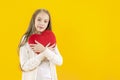 Valentine`s day. Declaration of love. A cute girl holding a red heart in her hands. Love. Congratulations on the holiday