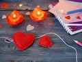 Valentine`s Day decor on a wooden textural table, a pair of large red felt hearts