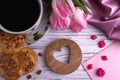 Valentine`s day elegant still life with tulip flowers cup of coffe marshmallow red heart shape sign on white wooden background