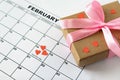 Valentine`s day, February 14 on the calendar with red hearts and gift box