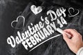 Valentine`s day on February 14th reminder written on chalkboard