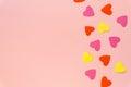 Multicolored paper hearts on pink background, space for text