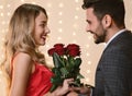 Valentine`s Day Flowers. Loving Man Giving Roses To His Happy Girlfriend