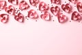 Valentine\'s Day frame border made of red paper hearts and confetti on pink background. Love, romance concept Royalty Free Stock Photo