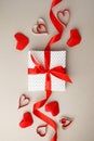 Valentine`s Day. Frame made of gift, origami hearts and ribbon on gray background. Valentines day background. Flat lay, top view,