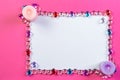 Valentine`s day frame on a pink background made of pebbles in the shape of a heart with white space and candles in the Royalty Free Stock Photo