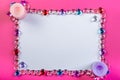 Valentine`s day frame on a pink background made of pebbles in the shape of a heart with white space and candles in the corners Royalty Free Stock Photo