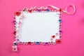 Valentine`s day frame on a pink background made of pebbles in the shape of a heart with white space and paper hearts and Royalty Free Stock Photo