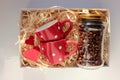 Valentine`s day gift box with two red espresso coffee cups, coffee beans in glass jar, and red hearts. Royalty Free Stock Photo