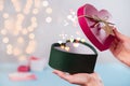 Valentine`s Day gifts in heart shaped box in hands, bokeh Royalty Free Stock Photo