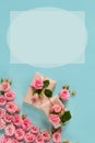 Valentine`s day banner.postcard favorite.Festive wreath of roses decoration with gifts and pink roses on a blue Royalty Free Stock Photo