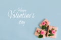 Valentine`s day banner.postcard favorite.Festive wreath of roses decoration with gifts and pink roses on a blue background. Royalty Free Stock Photo