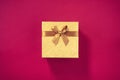 Valentine`s Day. Golden gift box on purple background. Top view. Copy space. Festive backdrop for holidays: Birthday Royalty Free Stock Photo