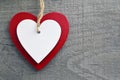 Valentine`s Day greeting card.Decorative red and white wooden hearts on a grey wooden background. Royalty Free Stock Photo