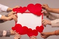 Valentine`s day greeting card. The hands of five girls hold felt hearts and a red frame. Mockup, copy space. Royalty Free Stock Photo