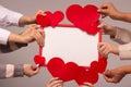 Valentine`s day greeting card. The hands of five girls hold felt hearts and a red frame. Mockup, copy space. Royalty Free Stock Photo