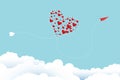 Valentine\'s day greeting card and love concept. A red plane flies, its path resembles a heart on clouds and a blue sky.