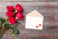 Valentine`s day greeting card with red rose flowers bouquet on a vintage on gray wooden table. Top view. Copy space Royalty Free Stock Photo